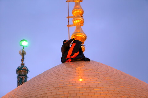 تصویری  رپورٹ|حرم حضرت معصومہ سلام اللہ علیھا کے گنبد مبارک پر پرچم حرم  امام  حسین  (ع) نصب