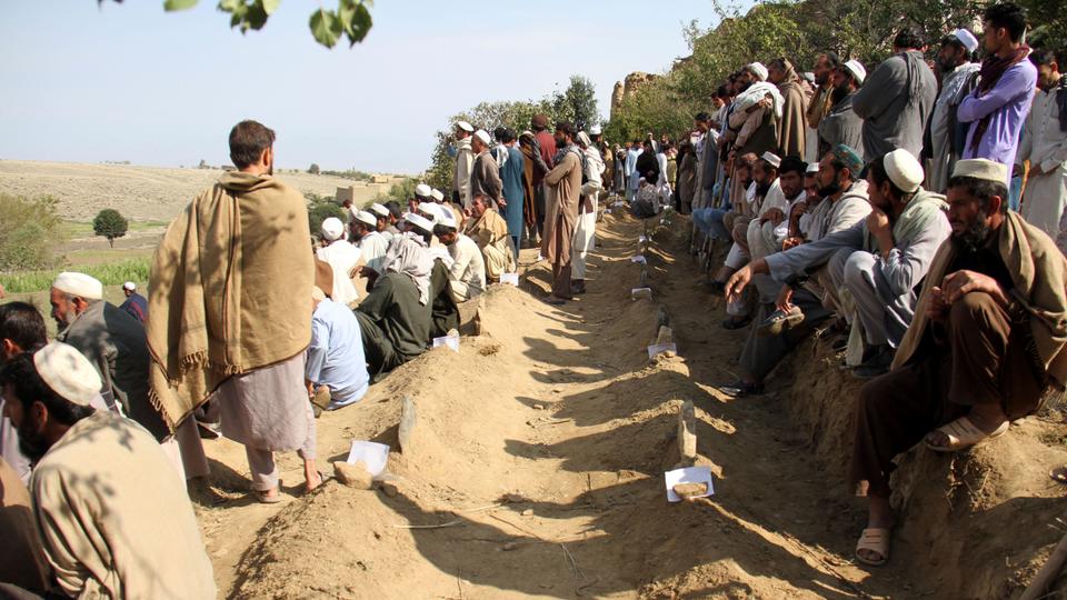 Afghan villagers search for bodies after 70 killed in mosque blast