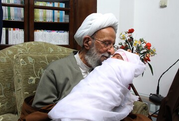 عکس/ مراسم نامگذاری فرزند یک طلبه توسط آیت الله مصباح یزدی