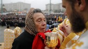 Believers from the Orthodox Cathedral in Romania shared with the same spoon