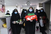 تصاویر/ توزیع لباس حضرت علی‌اصغر(ع) بین نوزادان بیمارستان فاطمیه همدان