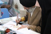 خوشنویسی طلاب در غرفه هنر قرآنی شانزدهمین نمایشگاه قرآن و عترت