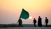 Arbaeen pilgrims walk at sunrise