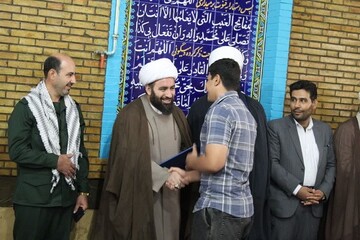 تجلیل از ایثارگران و قهرمانان ورزشی در بیستون