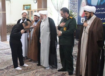 بوسه پدر شهید ولیزاده بر پیام آیت الله اعرافی