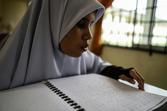 Blind Malaysian Muslims memorize Qur’an using Braille  